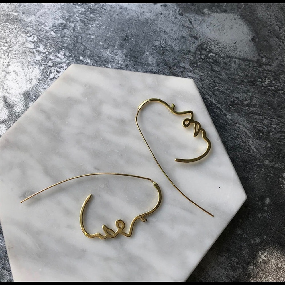 Golden face profile earrings
